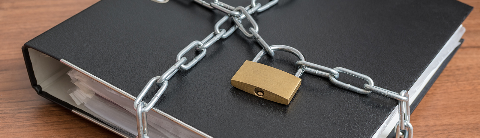 three ring binder on a table with a lock and chains