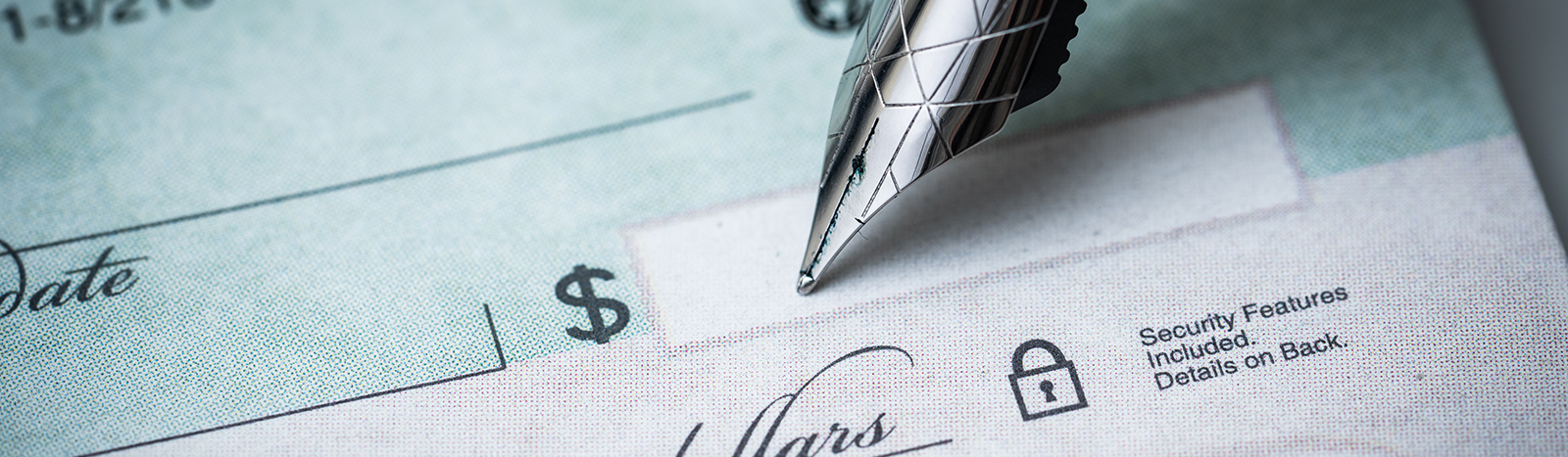 fountain pen sitting on a check