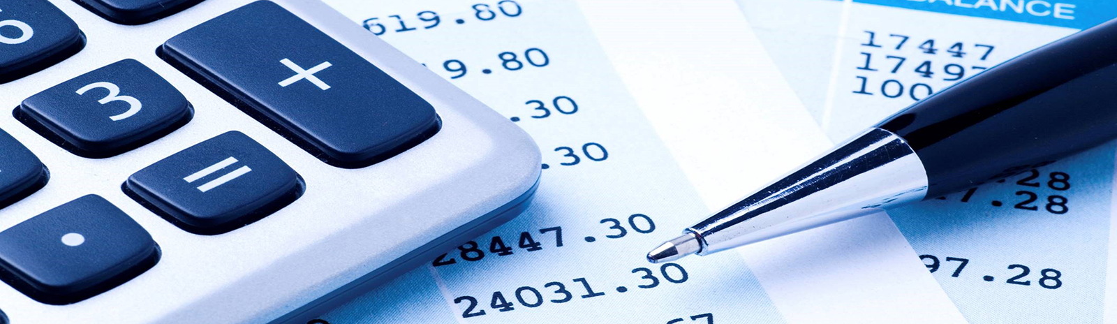 a calculator and pen sitting on a balance sheet